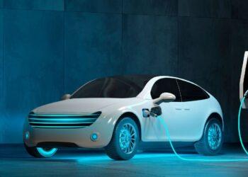 Electric White Electric Car Charging at a Futuristic Station with a Blue Glow on the Floor and Charger Cable Plugged in - Regios Al Cuadrado Electric White Electric Car Charging at a Futuristic Station with a Blue Glow on the Floor and Charger Cable Plugged in - Regios Al Cuadrado